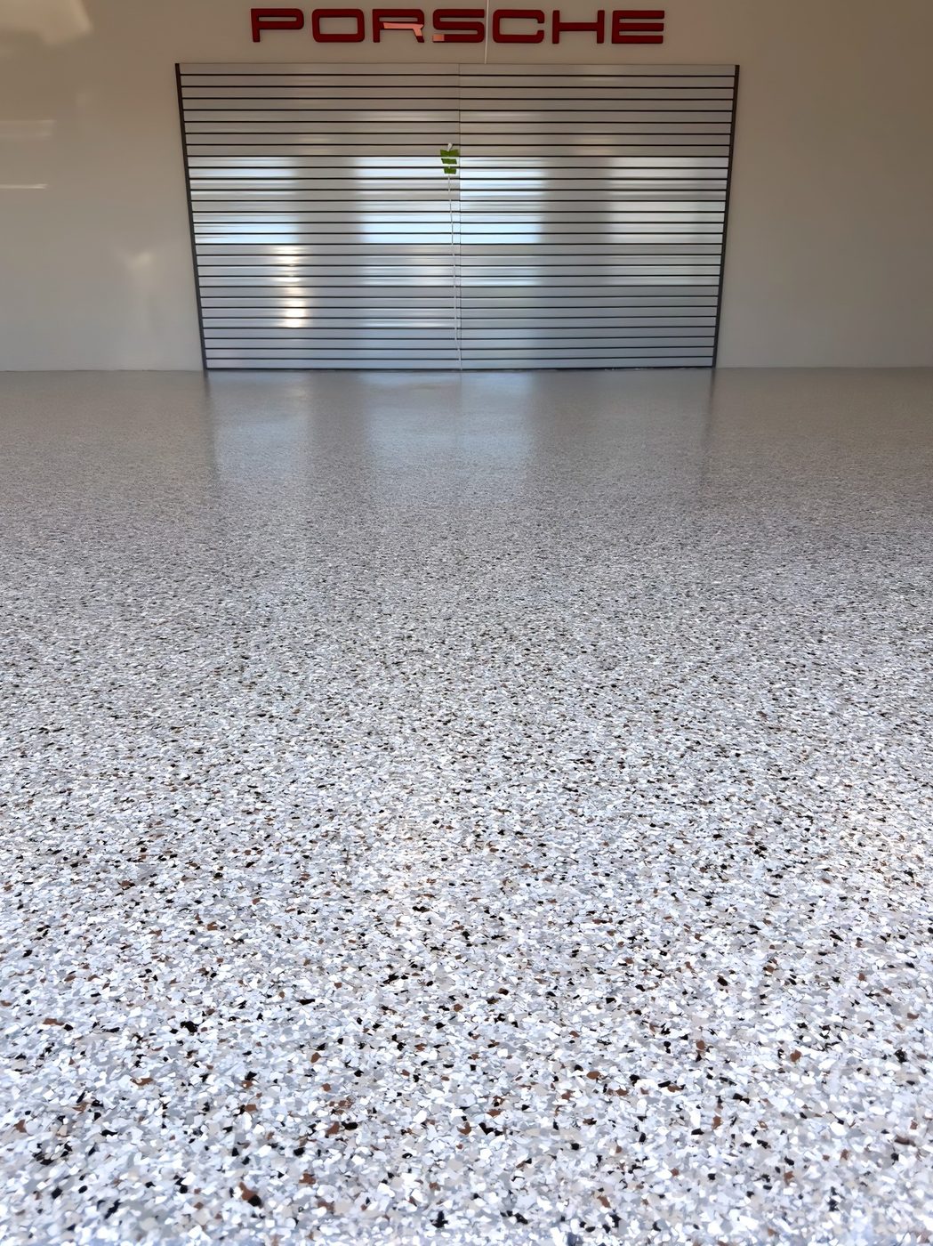 Finished decorative garage floor in Porsche-themed garage